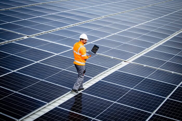 Renewable,Energy,Engineer,Walking,Through,Large,Solar,Power,Plant,And