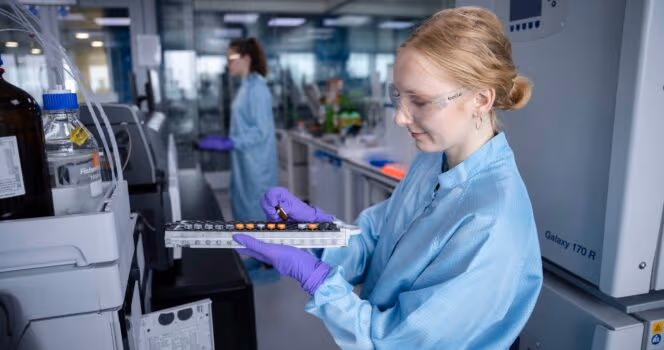 Scientist with a tray of samples